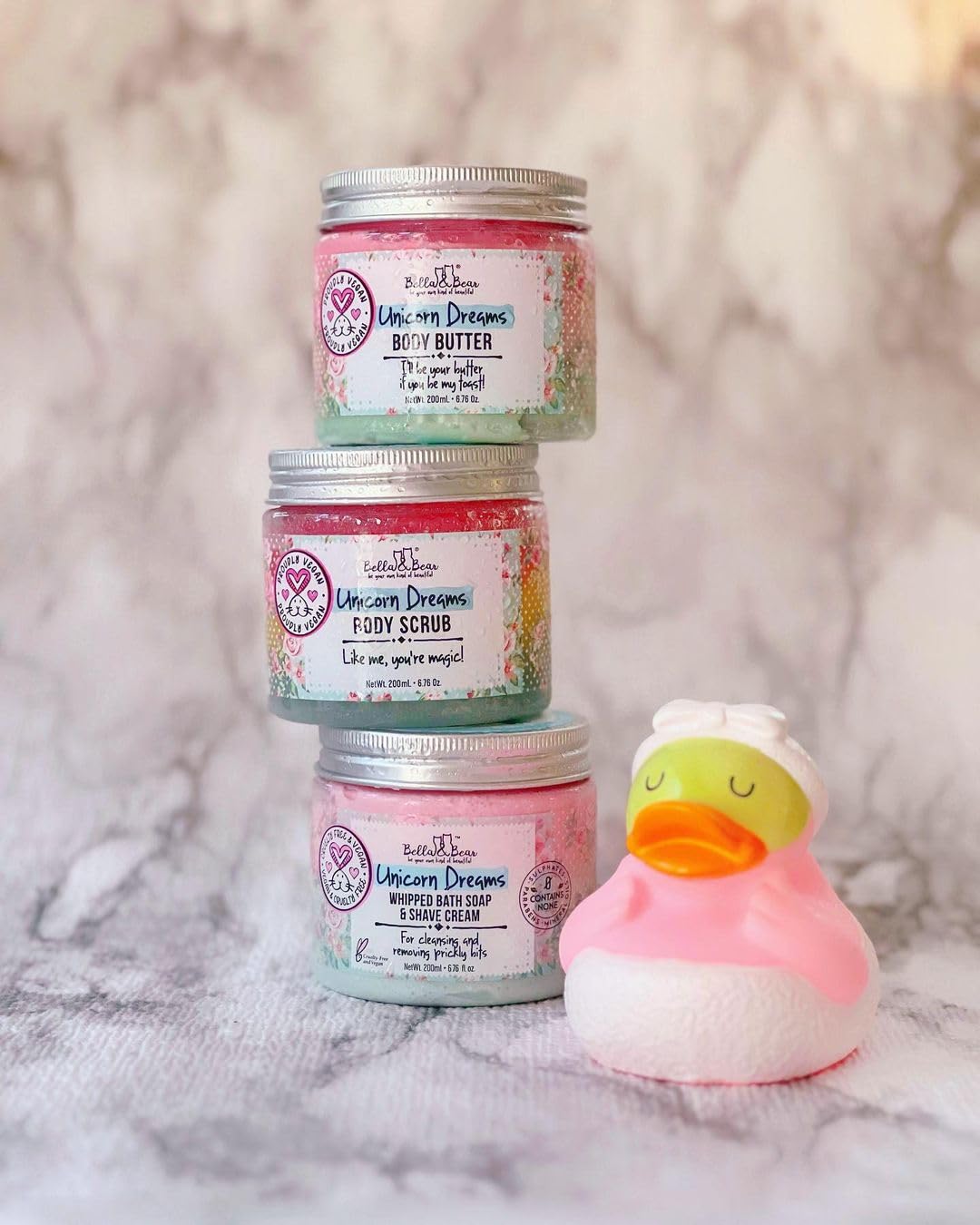 Bella & Bear Unicorn Dream Body Scrub in hand ready for application.