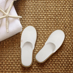 Individually wrapped BERGMAN KELLY spa slippers for hygienic distribution