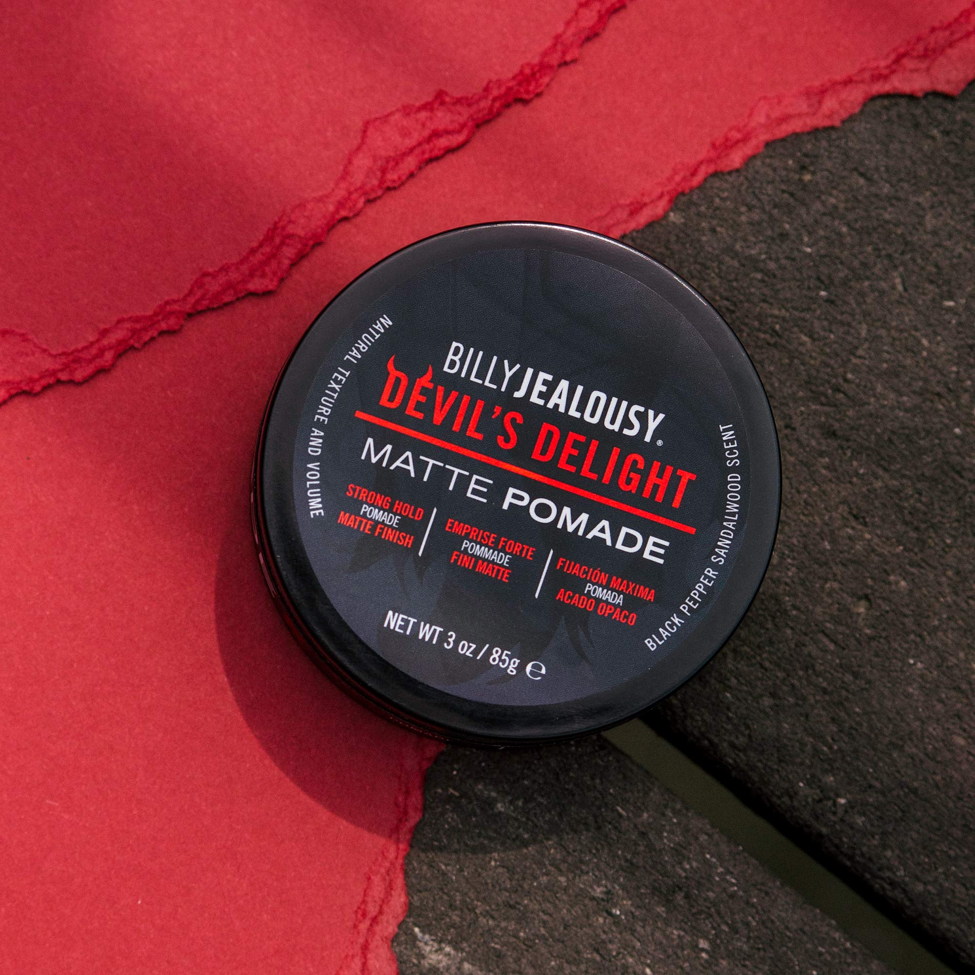 Billy Jealousy Devil's Delight hands applying pomade for even distribution.