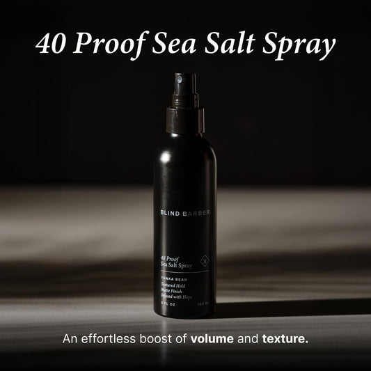 Applying Blind Barber spray to damp hair for lift from roots
