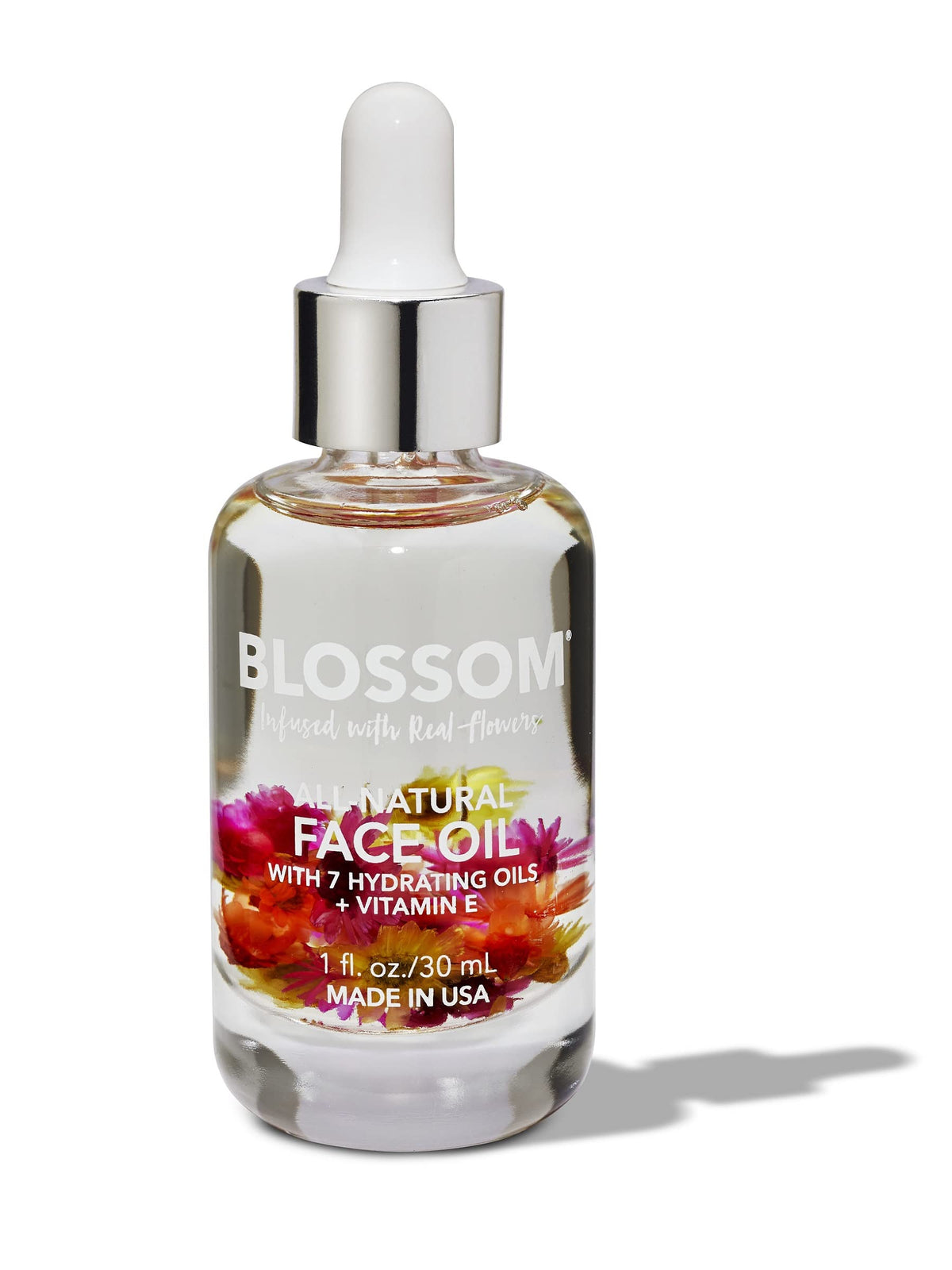 Blossom face oil real flowers bottle close-up for radiant hydration.