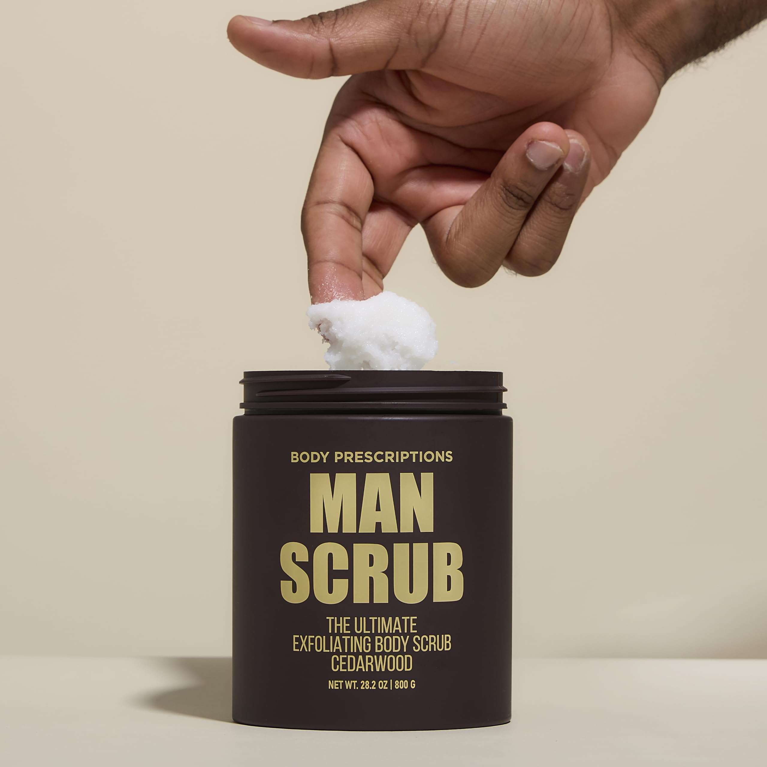 Body Prescriptions cedarwood scented scrub application demonstrates full-body use.