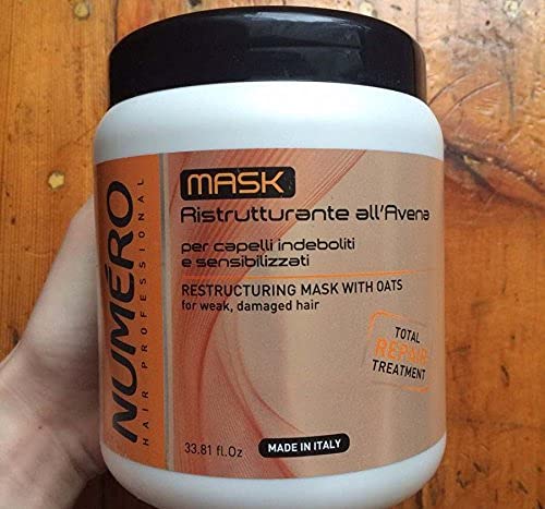 Application of Brelil Numero oat mask on wet hair during routine care.