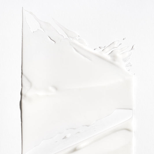 Briogeo Curl Charisma cream texture close-up highlights creamy moisture for soft results.