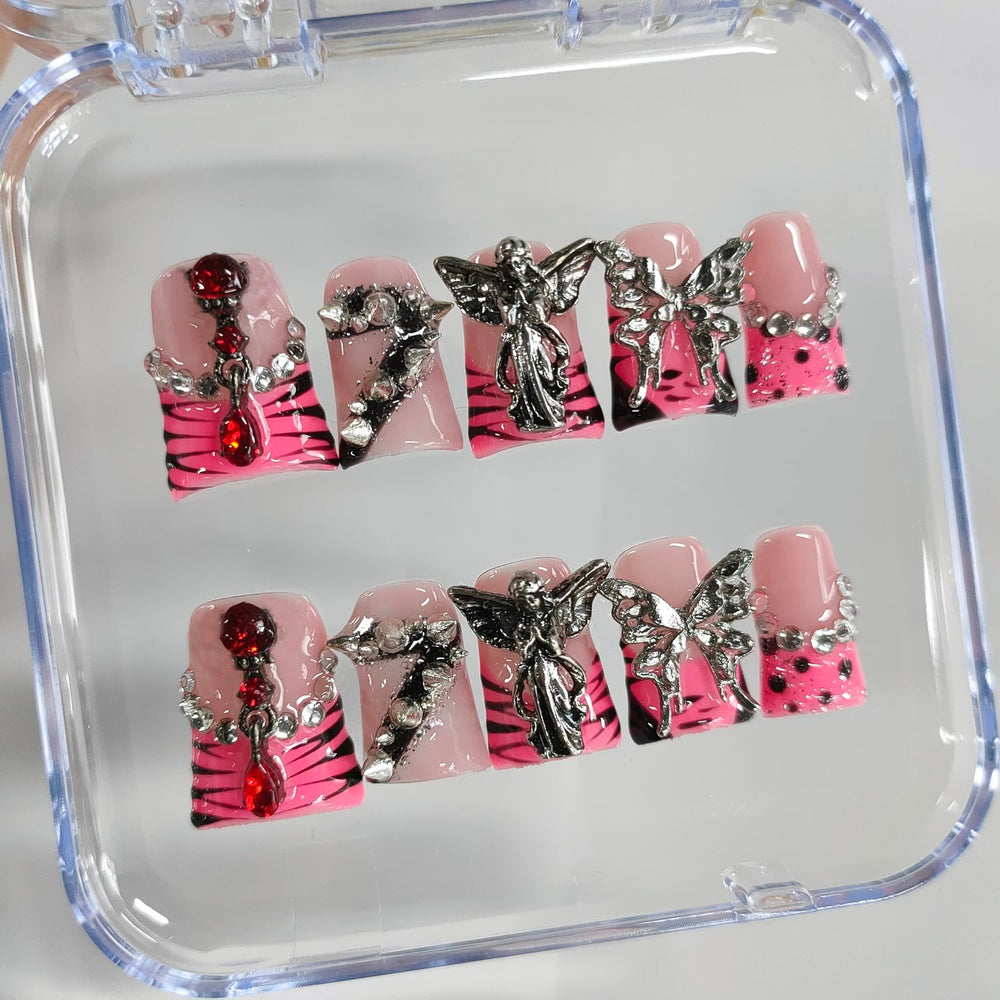 BRKYKGK nails with angel charms and rhinestones for decorative accents.