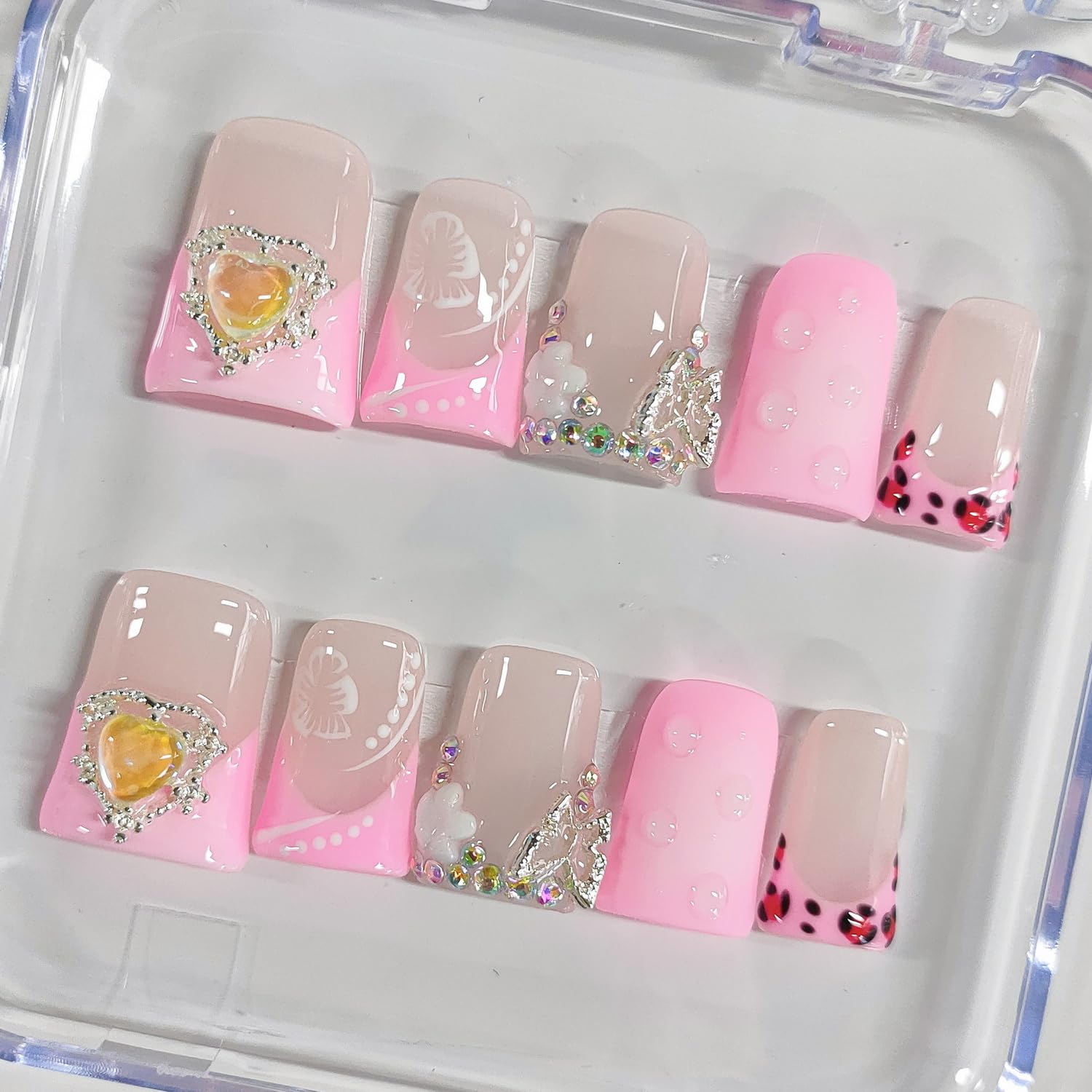 BRKYKGK French tip nails with hibiscus rhinestones add sparkle to any look