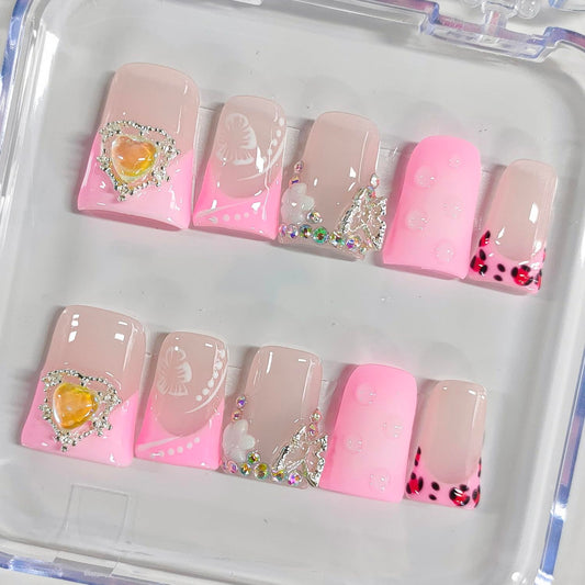 BRKYKGK French tip nails with hibiscus rhinestones add sparkle to any look