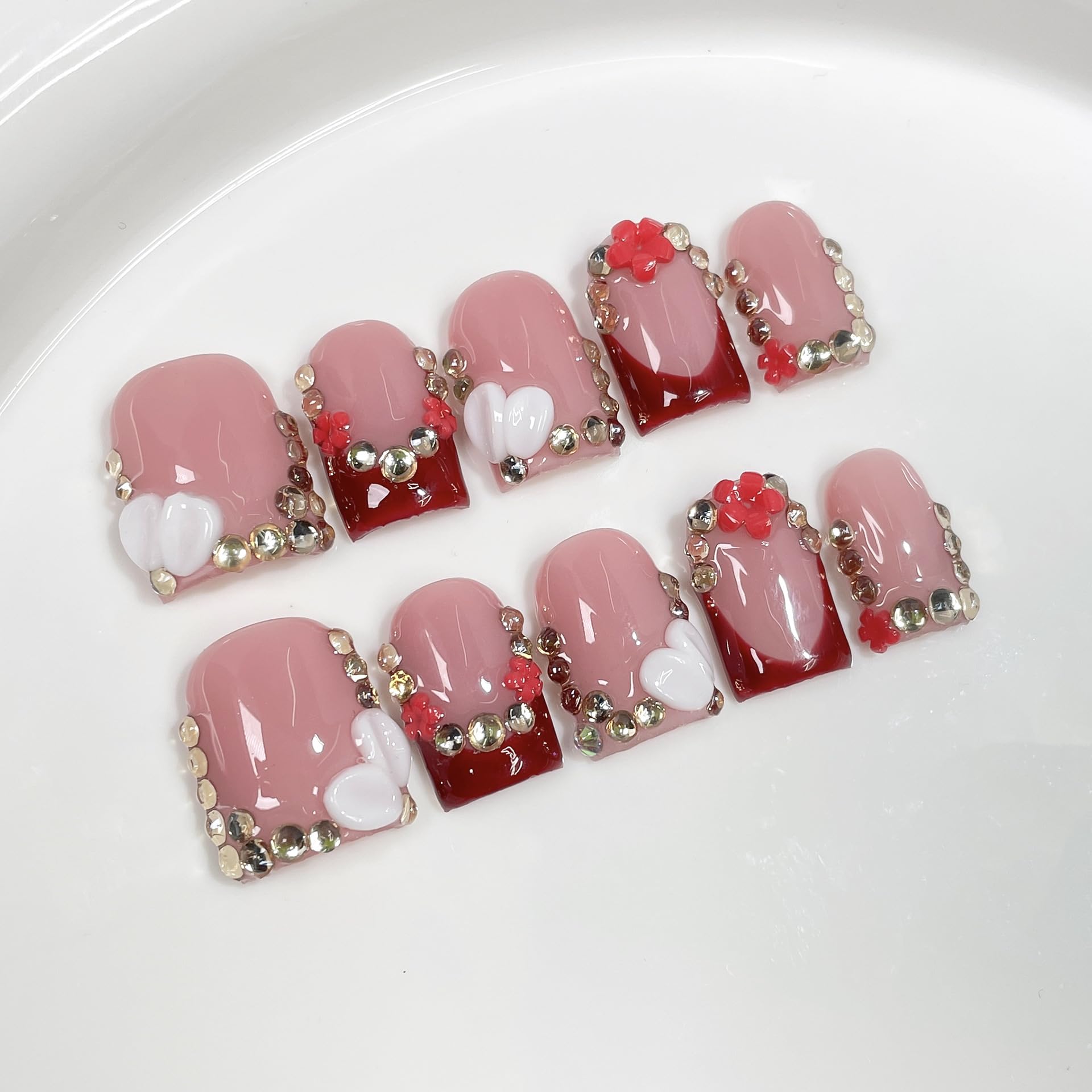 BRKYKGK French Tip nails with floral rhinestones for a chic look.