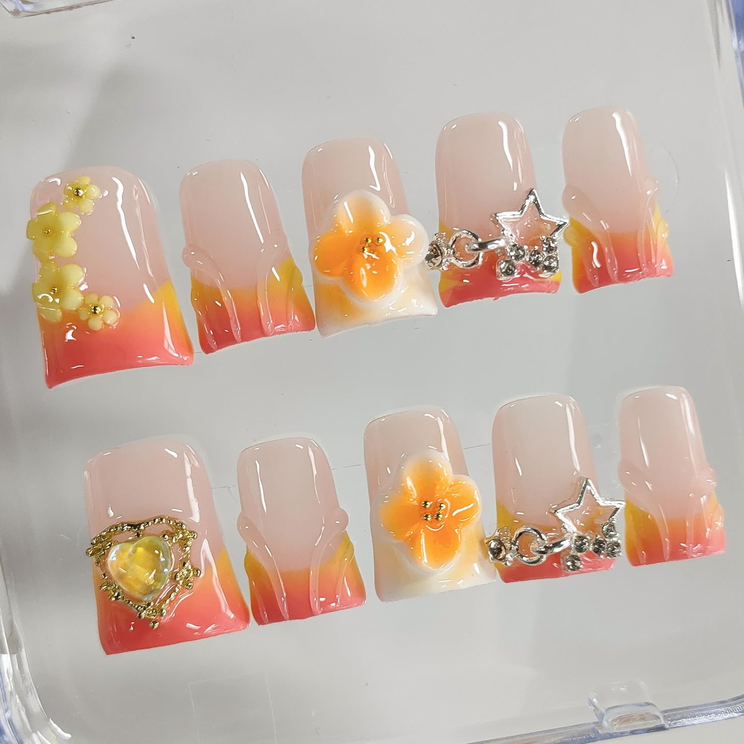 BRKYKGK orange false nails with flower stars and heart designs