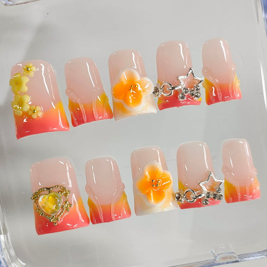 BRKYKGK orange false nails with flower stars and heart designs