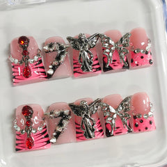 BRKYKGK pink French tip nails with spikes for edgy everyday glam.