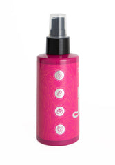 Brujeria hair spray close-up bottle and misty application moment