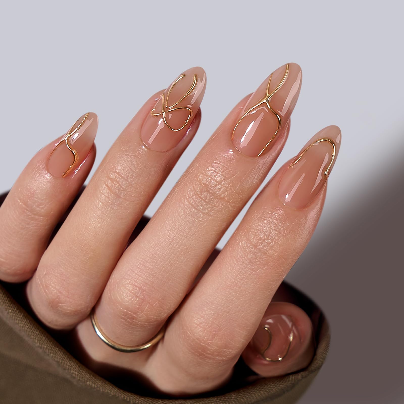 BTArtbox almond nails with 3D gold lines for a luxe look.