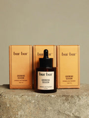 BUR BUR Growing Season oil bottle on wood for nourishing scalp care