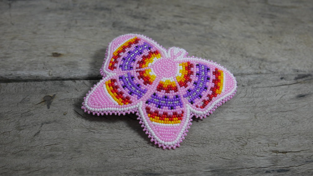 BuyBeaded beadwork close-up reveals tiny zirconia beads and multicolored patterns.