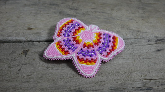 BuyBeaded beadwork close-up reveals tiny zirconia beads and multicolored patterns.