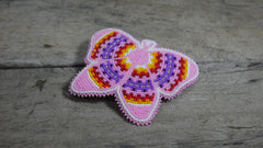 BuyBeaded beadwork close-up reveals tiny zirconia beads and multicolored patterns.