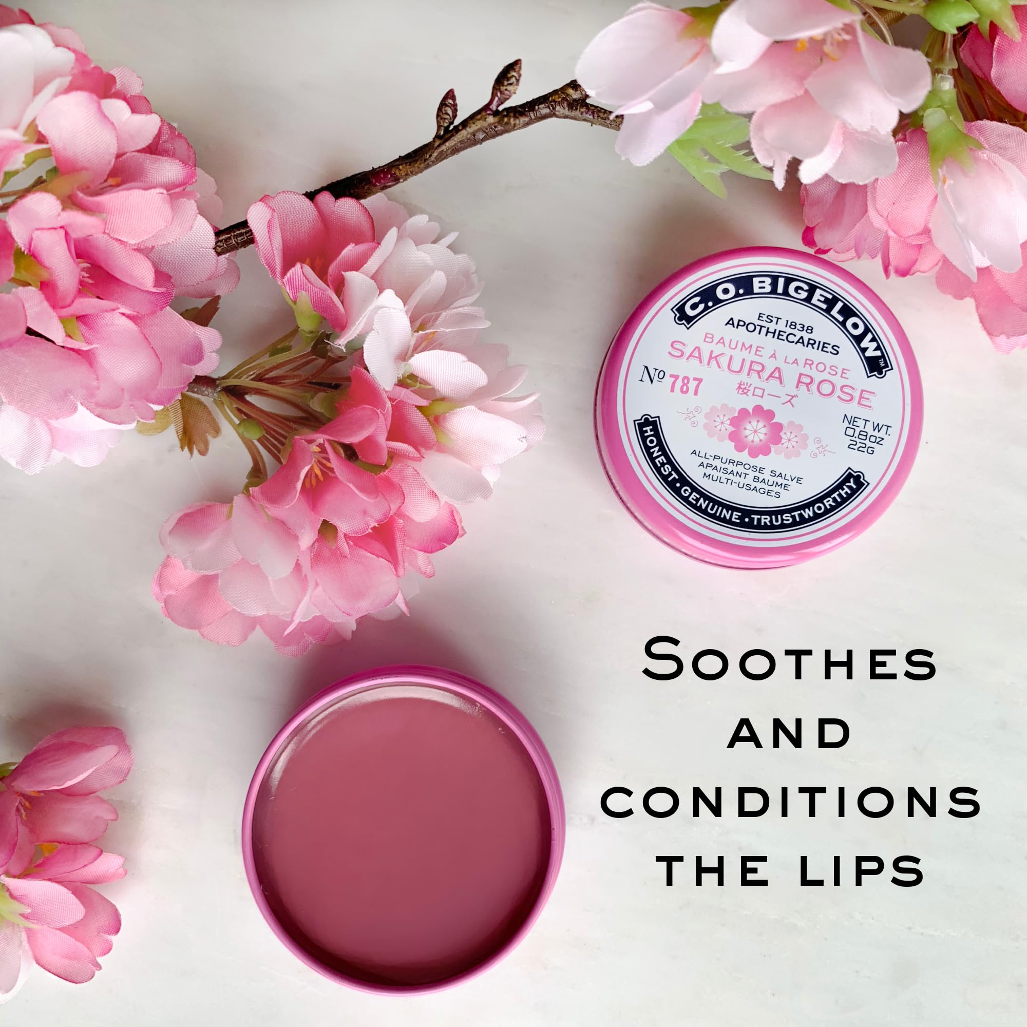 Applying C.O. Bigelow Sakura Rose Salve on lips for softness