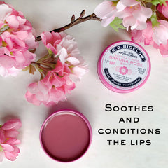 Applying C.O. Bigelow Sakura Rose Salve on lips for softness