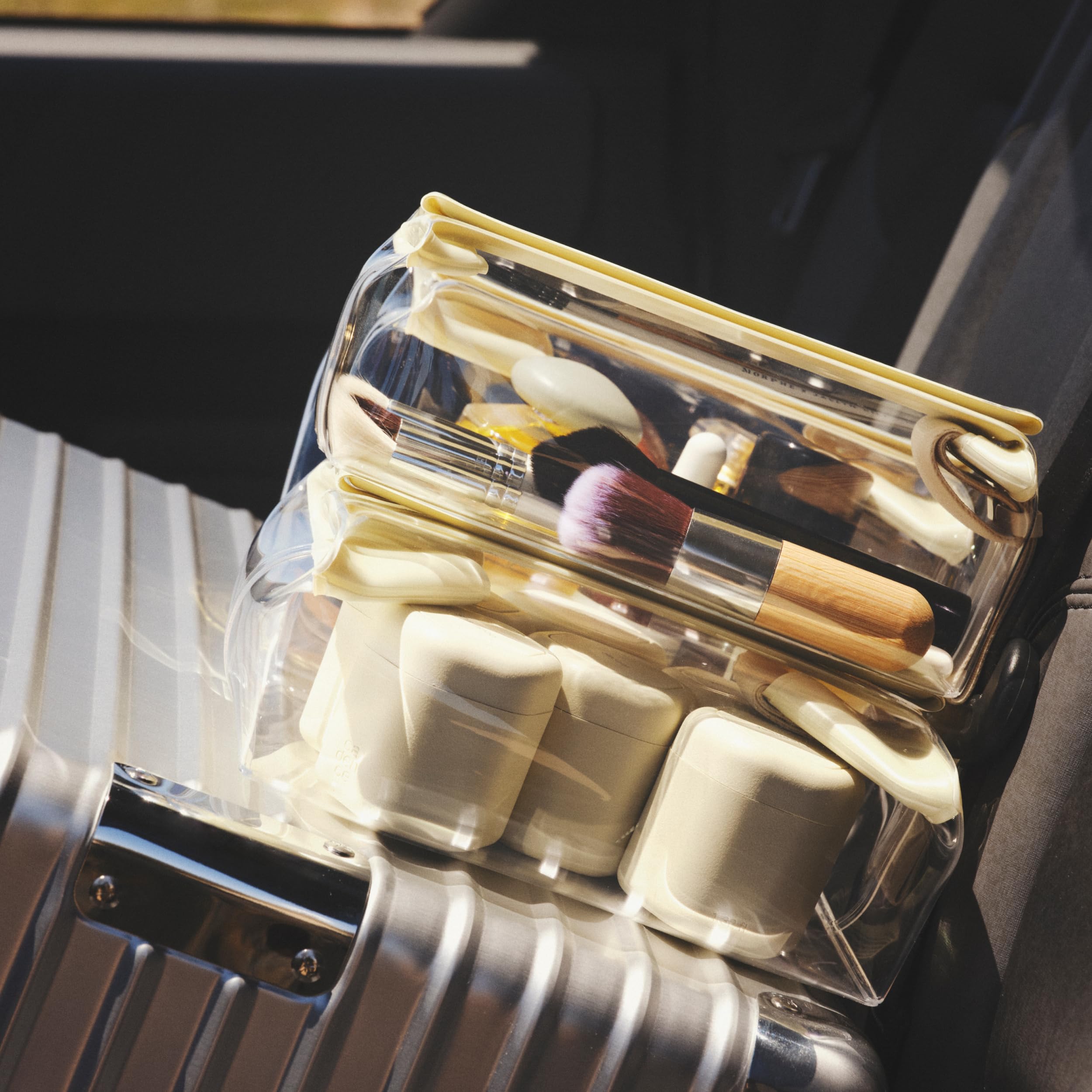 Cadence daily routine capsules organized in a carry-on for travel.