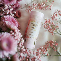 Camille Beckman talc-free powder being gently applied to dry areas.