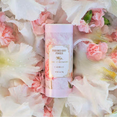 Camille Beckman fragranced talc-free powder dusting action for freshness.