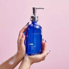 Capri Blue bottle pump-action close-up showing easy one-handed dispense.