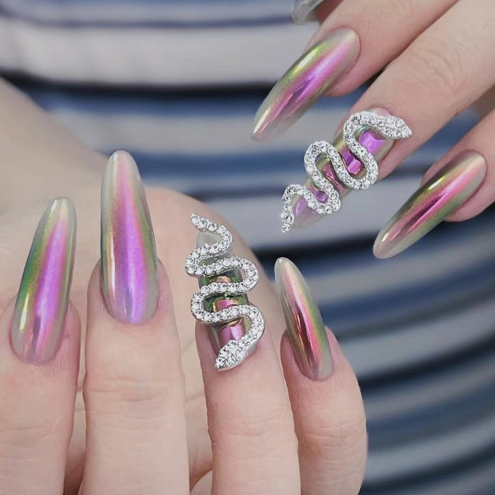 CHARMING MAY Chameleon chrome powder being brushed onto a natural nail.