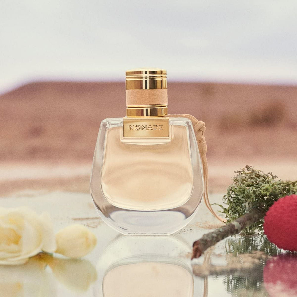 Chloe Nomade Mini drops on skin surface hint at lasting charm.