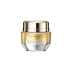 Clé de Peau Beauté mini volumizing cream supreme texture closeup shows silky feel for luxurious application.