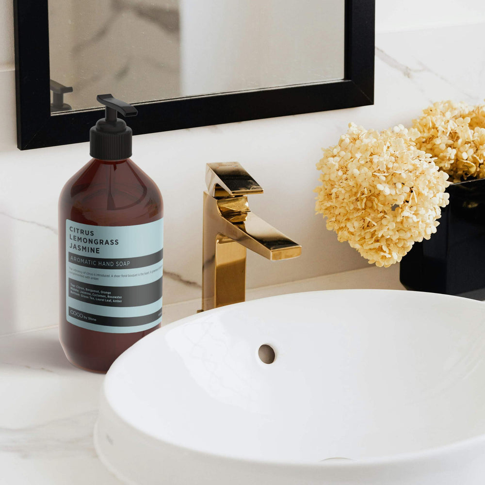 COCO by Stone hand soap pump on sink for hotel-inspired cleansing.