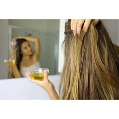 Hands applying Cocojojo Vitamin E Oil for a lightweight, soothing touch.