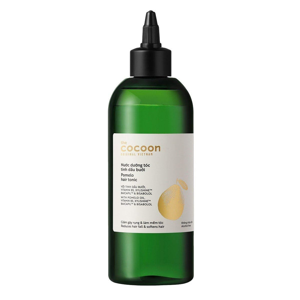 Cocoon Original Pomelo Oil Hair Tonic bottle pours for scalp care ritual