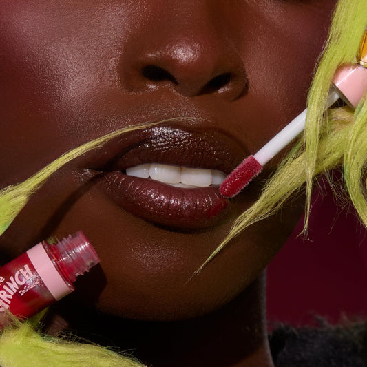 ColourPop Grinchmas Swirl lip gloss swatch reveals sheer color and pearly shimmer.