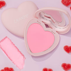 Close-up of the Silky Powder Blush being applied with a blush brush.