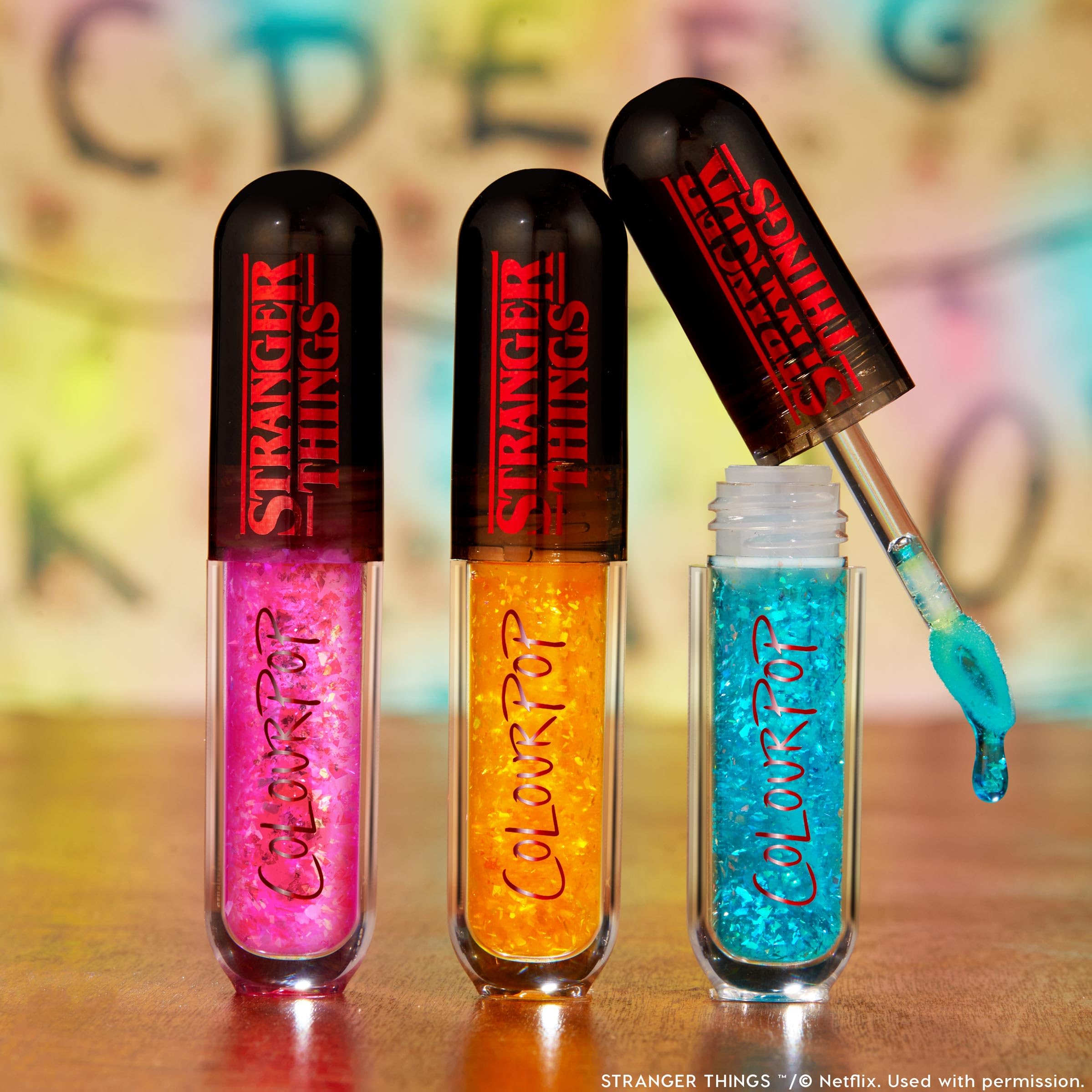 ColourPop Talk to Me gloss trio on festive lighting appears vibrant and party-ready.