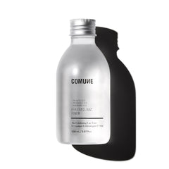 COMUNE AHA Exfoliant Toner bottle pour showing gentle exfoliation and pore refinement.