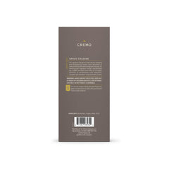 Cremo Vintage Suede bottle with amber backdrop, showcases rich suede notes.