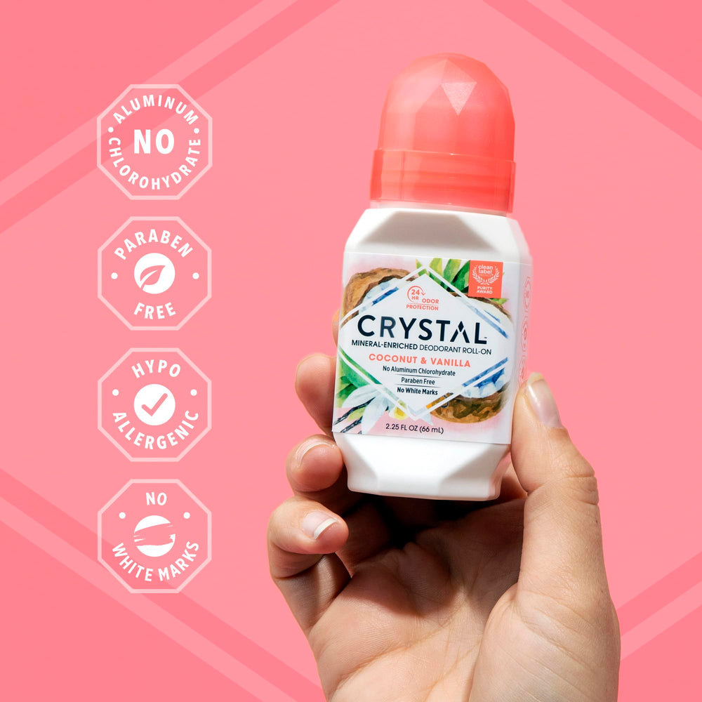 Crystal Essence Coconut Vanilla roll-on being applied to underarm.