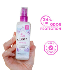 Crystal Essence Mineral Deodorant Spray on feet for quick-drying odor protection.