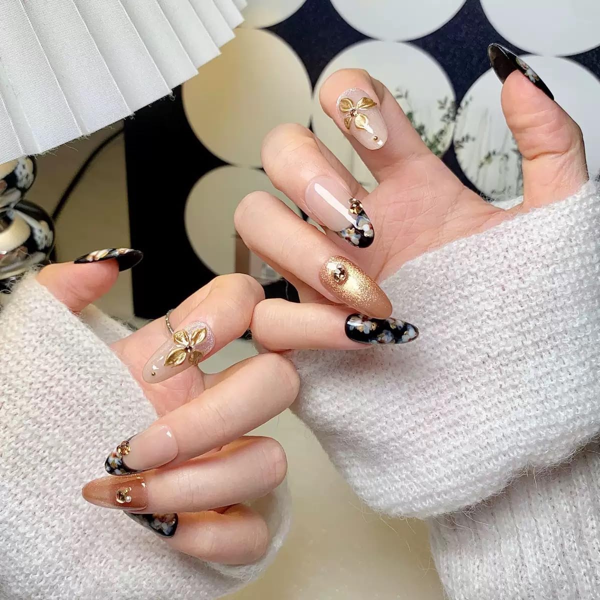 CTTHNBD almond press-on nails close-up shows flower design and luxe finish.