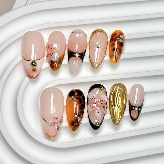 CTTHNBD almond press-on nails with 3D gold flowers for salon-style manicure at home.