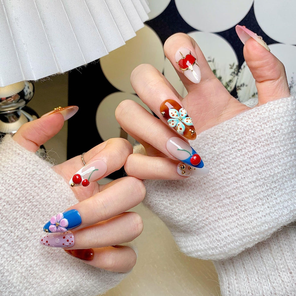 Cherry flower heart design on almond nails adds a delicate touch for parties.