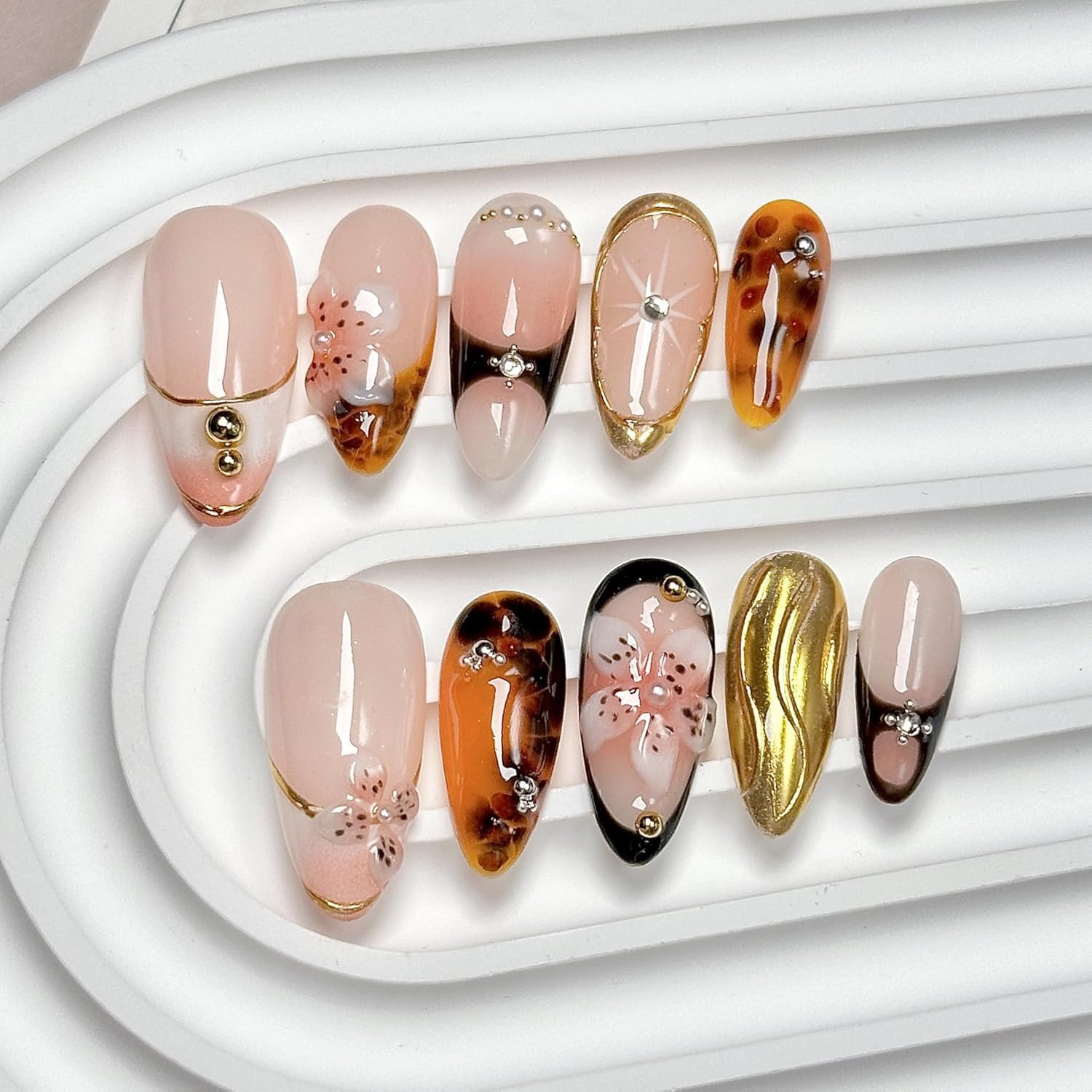 CTTHNBD Medium Almond press-on nails with brown gold flower design for a chic manicure.