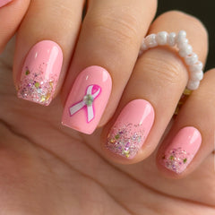 Curvlife press-on nails with pink ribbon glitter and glossy finish for instant glamour.