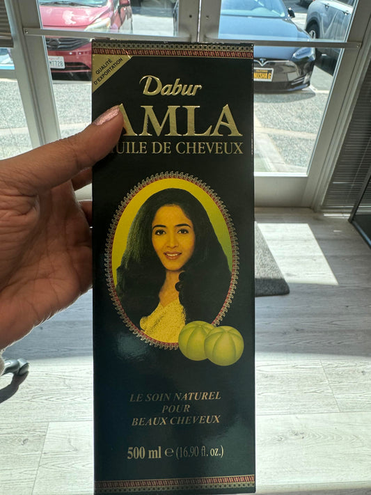 Dabur Amla Hair Oil application scene showing massaging hair.