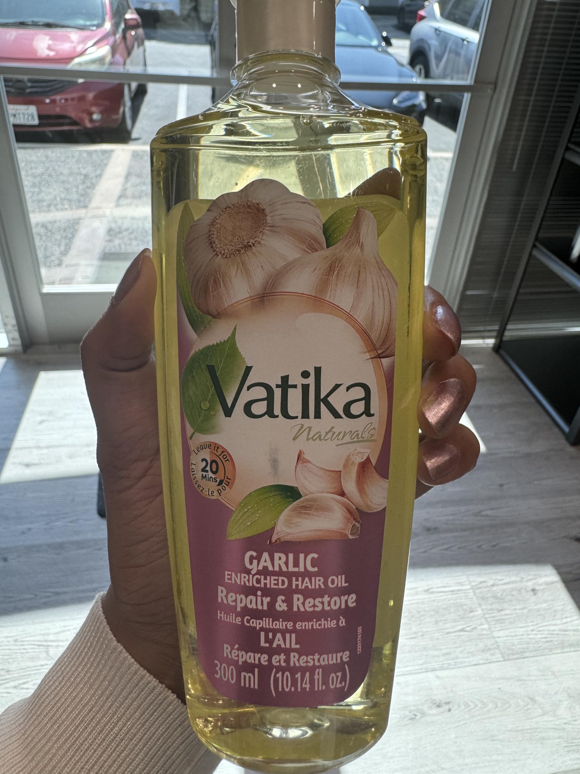 Dabur Vatika Enriched Hair Oil garlic essence bottle promotes scalp nourishment.