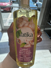 Dabur Vatika Enriched Hair Oil garlic essence bottle promotes scalp nourishment.
