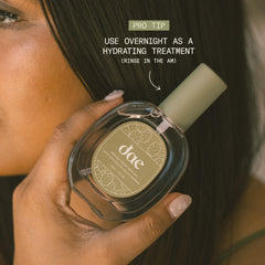 Hands apply DAE Prickly Pear Oil to damp hair