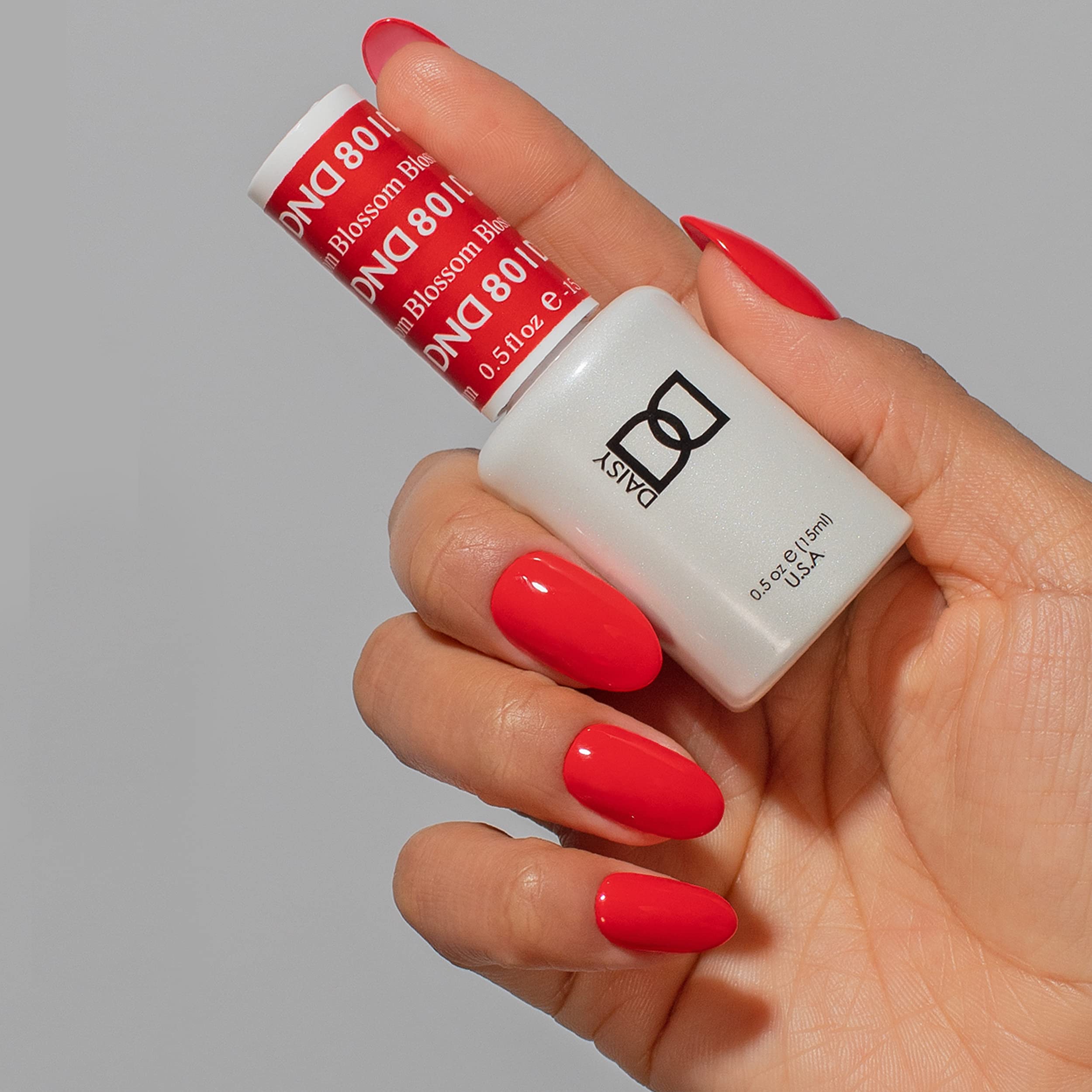 Daisy DND Blossom lacquer bottle highlights a matching red finish for salon-worthy nails.